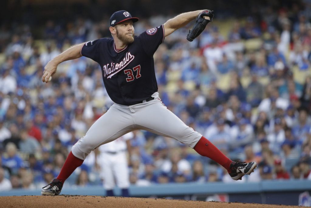 Washington Nationals starting pitcher Stephen Strasburg throws to a Los Angeles Dodgers batter during the first inning in Game 5 of a baseball National League Division Series on Wednesday, Oct. 9, 2019, in Los Angeles.