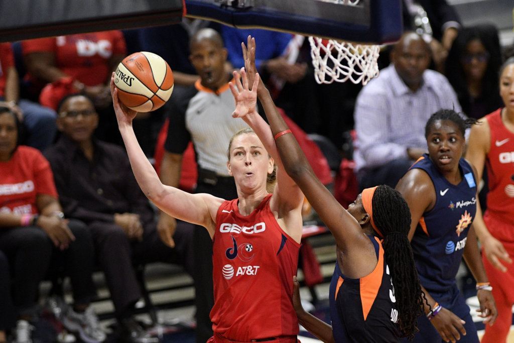 Washington Mystics center Emma Meesseman, left, goes to the basket against Connecticut Sun forward Jonquel Jones, bottom right, in the first half of Game 5 of basketball's WNBA Finals, Thursday, Oct. 10, 2019, in Washington.