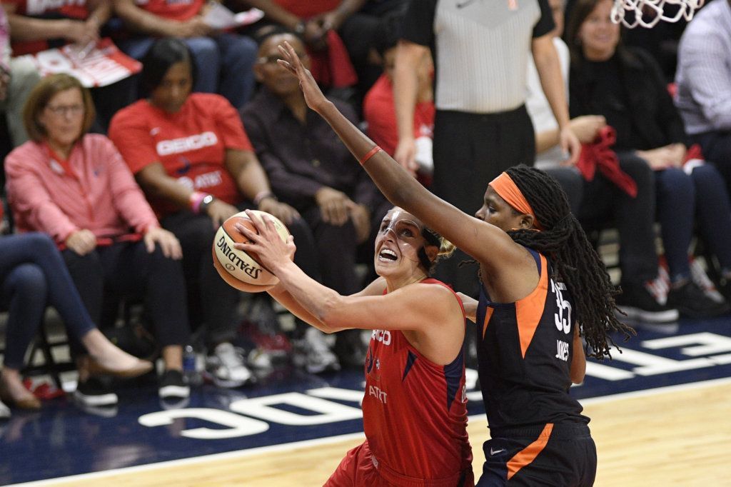 Washington Mystics forward Elena Delle Donne, left, goes to the basket as Connecticut Sun forward Jonquel Jones defends during the first half of Game 5 of basketball's WNBA Finals, Thursday, Oct. 10, 2019, in Washington. Delle Donne was fouled on the play.