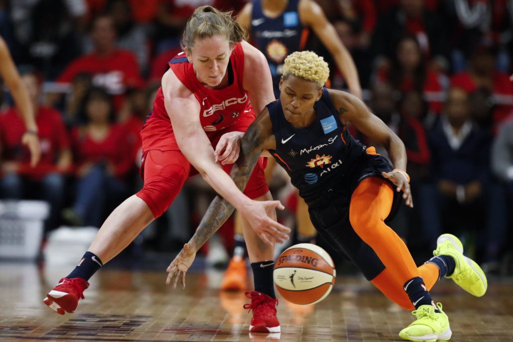 Washington Mystics center Emma Meesseman, left, and Connecticut Sun guard Courtney Williams go for the ball during the first half of Game 5 of basketball's WNBA Finals, Thursday, Oct. 10, 2019, in Washington.
