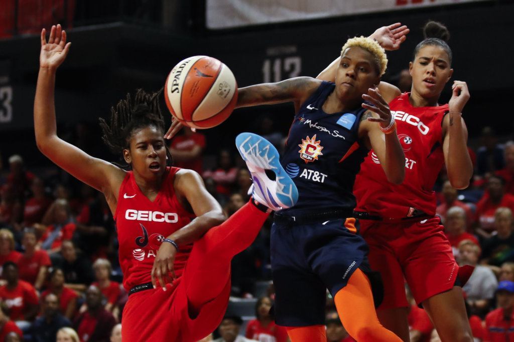 Washington Mystics guard Ariel Atkins, left, Connecticut Sun guard Courtney Williams and Washington Mystics guard Natasha Cloud watch as the ball heads out of bounds during the first half of Game 5 of basketball's WNBA Finals, Thursday, Oct. 10, 2019, in Washington.