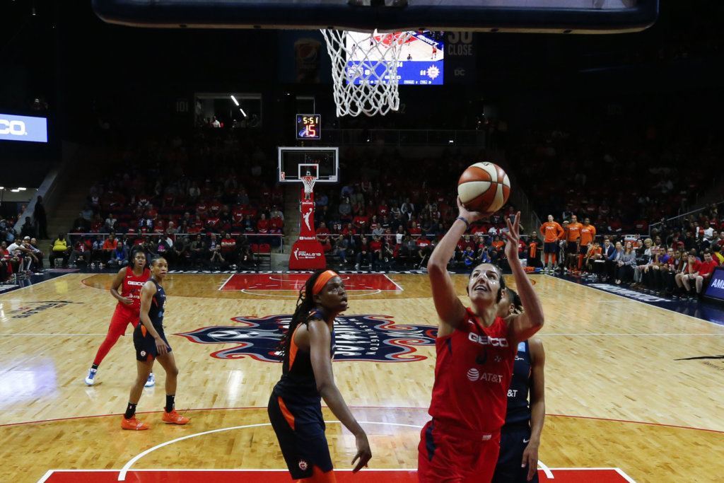 Washington Mystics forward Elena Delle Donne, right, shoots during the first half of Game 5 of basketball's WNBA Finals against the Connecticut Sun, Thursday, Oct. 10, 2019, in Washington.