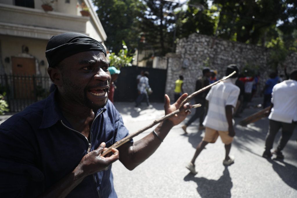 A man participates in an anti-government protest in Port-au-Prince, Haiti, Friday, Oct. 11, 2019.