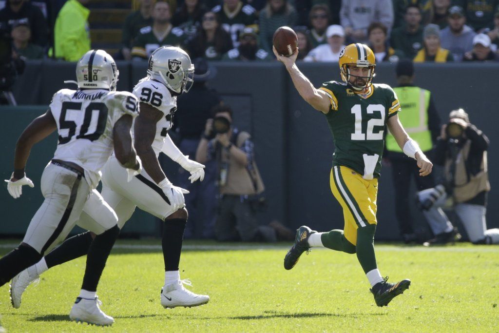 Green Bay Packers' Aaron Rodgers throws during the first half of an NFL football game against the Oakland Raiders Sunday, Oct. 20, 2019, in Green Bay, Wis.