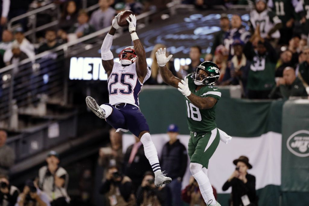 New England Patriots' Terrence Brooks (25) intercepts a pass to New York Jets' Demaryius Thomas (18) during the second half of an NFL football game, Monday, Oct. 21, 2019, in East Rutherford, N.J.