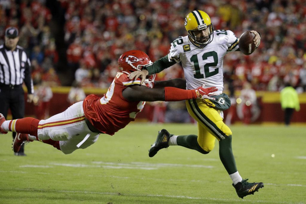 Green Bay Packers quarterback Aaron Rodgers (12) is tackled by Kansas City Chiefs defensive tackle Khalen Saunders (99) during the second half of an NFL game against the Kansas City Chiefs in Kansas City, Mo., Sunday, Oct. 27, 2019.