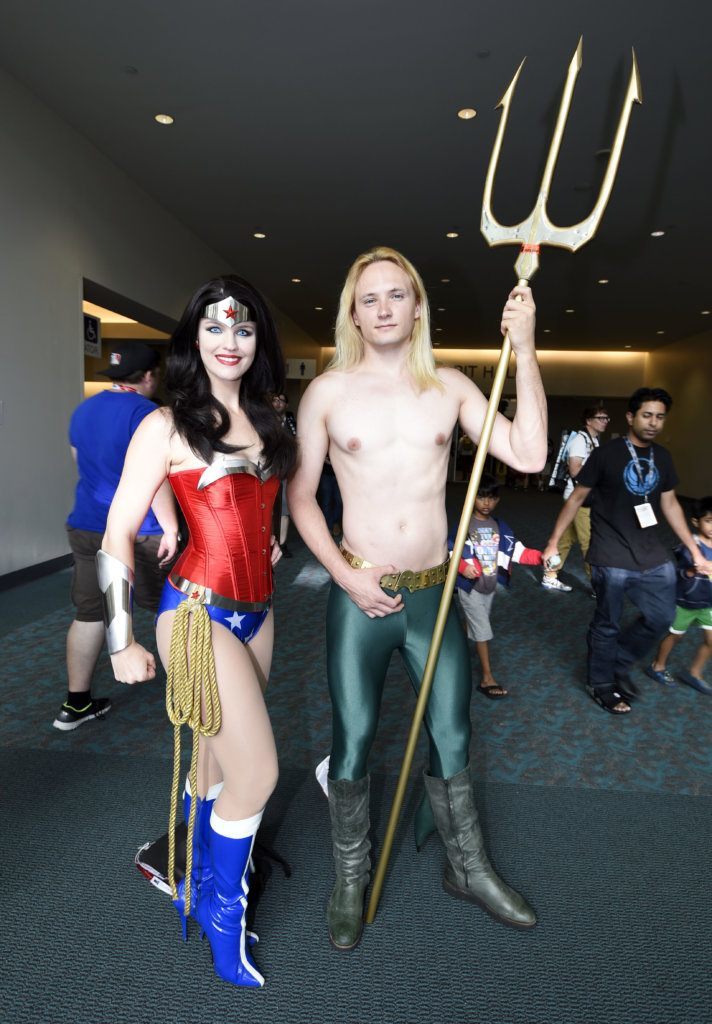 Sayayohn, dressed as Wonder Woman, and Dakotah Luster, dressed as Aquaman, pose for photographers on the second day of the 2015 Comic-Con International held at the San Diego Convention Center Friday, July 10, 2015, in San Diego.