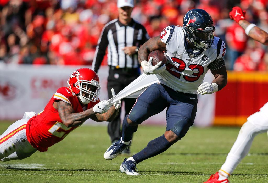 KANSAS CITY, MO - OCTOBER 13: Bashaud Breeland #21 of the Kansas City Chiefs holds on to the jersey of Carlos Hyde #23 of the Houston Texans in the fourth quarter at Arrowhead Stadium on October 13, 2019 in Kansas City, Missouri.