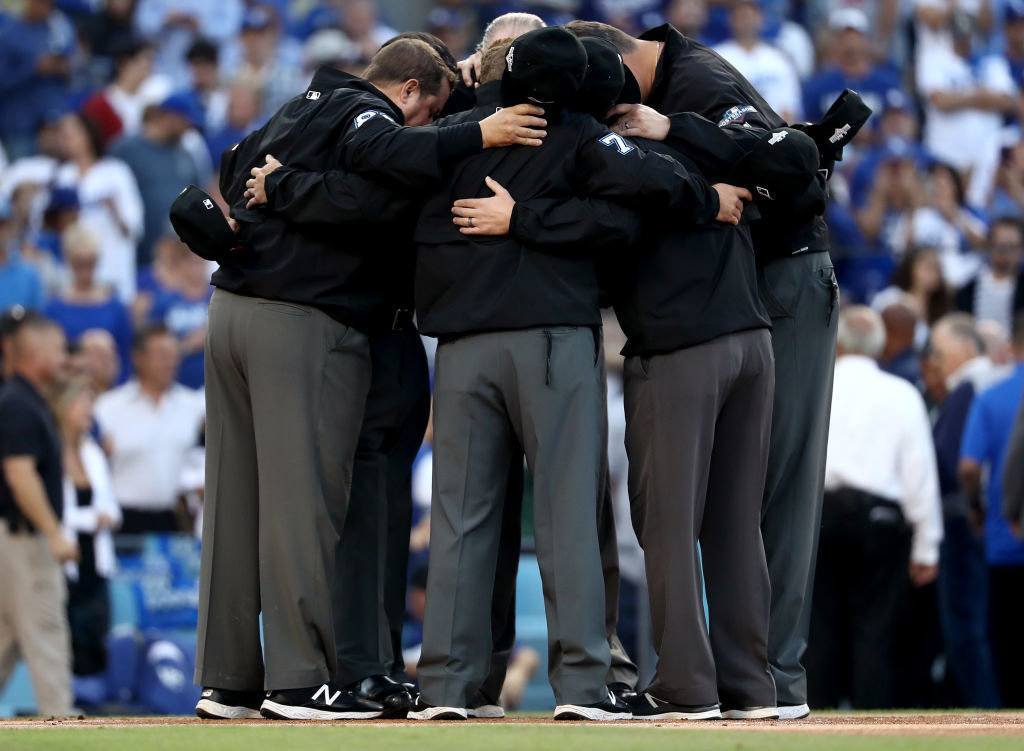 LOS ANGELES, CALIFORNIA - OCTOBER 09: The umpires gather before game five of the National League Division Series between the Washington Nationals and the Los Angeles Dodgers at Dodger Stadium on October 09, 2019 in Los Angeles, California.