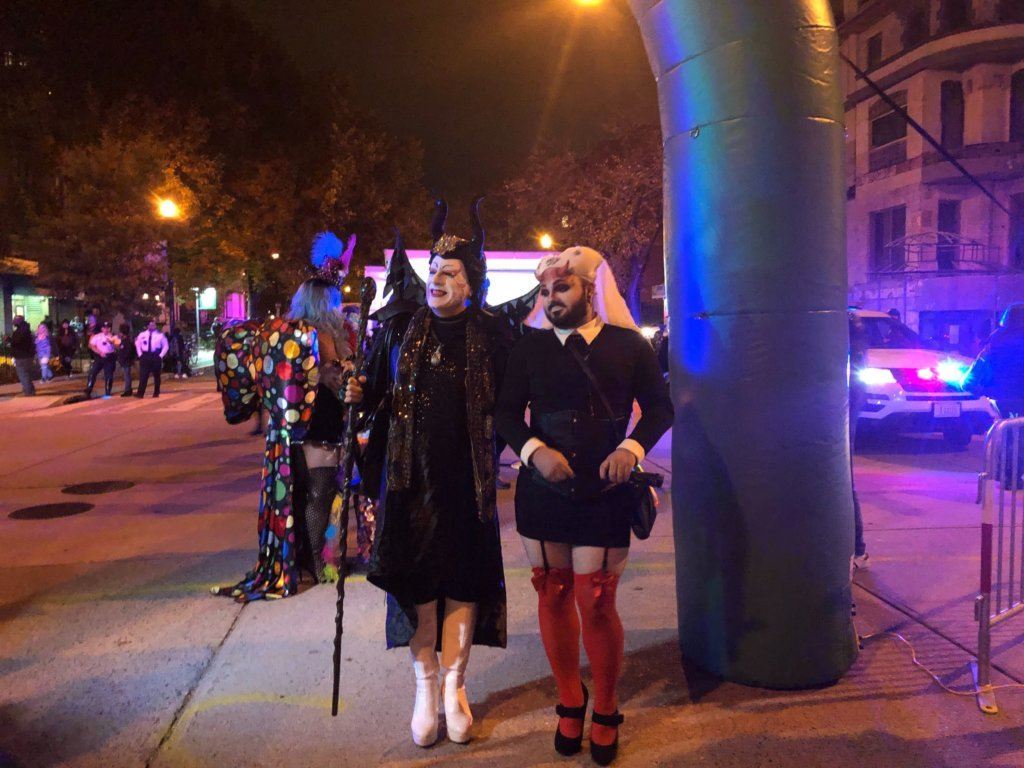 Costumed participants stand on 17th Street during the High Heel Race.
