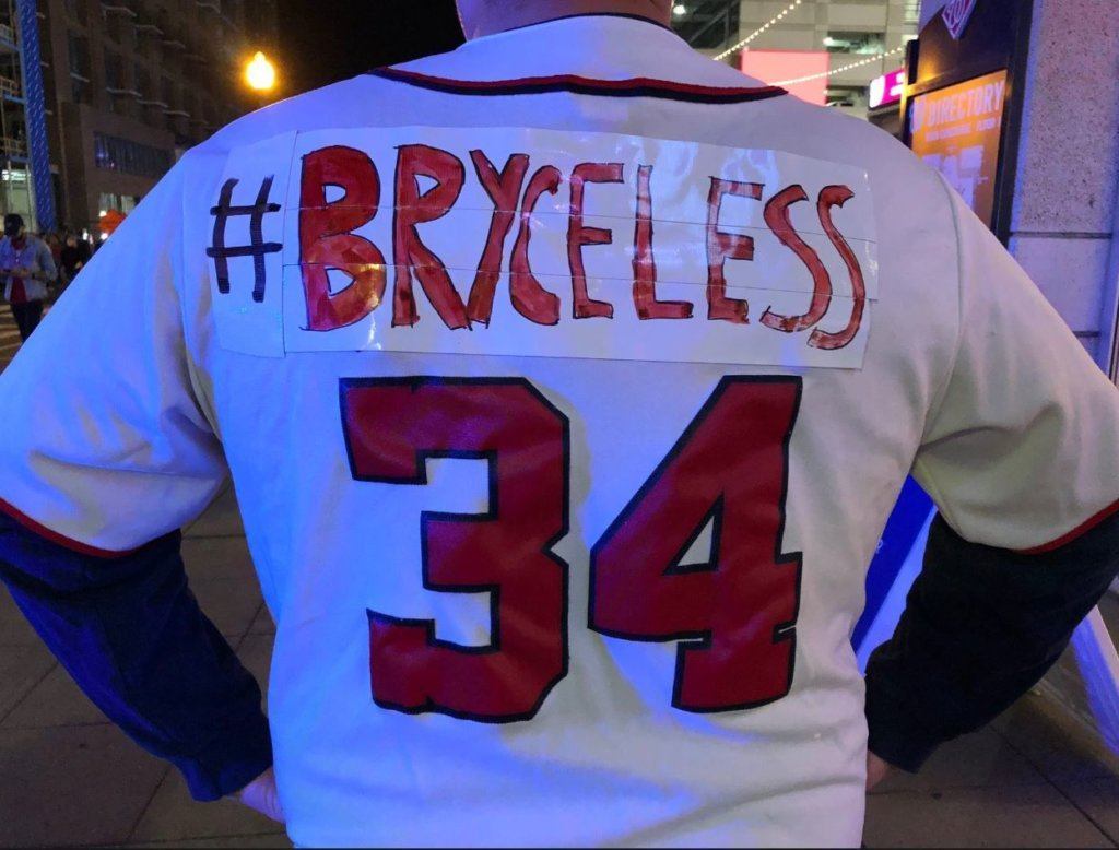 A fan shows off former Nationals player Bryce Harper's old number during Game 3 of NLCS on Tuesday, Oct. 15, 2019 in D.C.