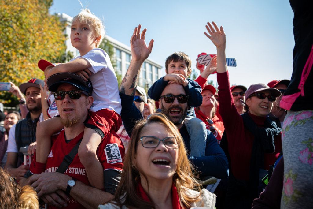 Nationals fans cheer the passing of the Commissioner's Trophy along Constitution Avenue.