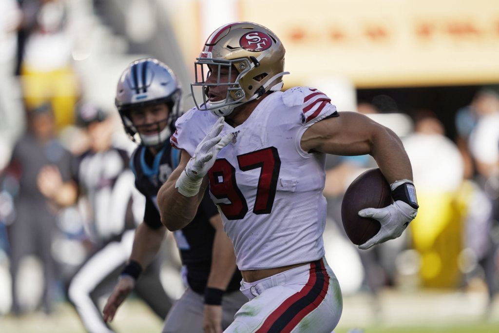 San Francisco 49ers defensive end Nick Bosa runs with the ball after making an interception during the second half of an NFL football game against the Carolina Panthers in Santa Clara, Calif., Sunday, Oct. 27, 2019.