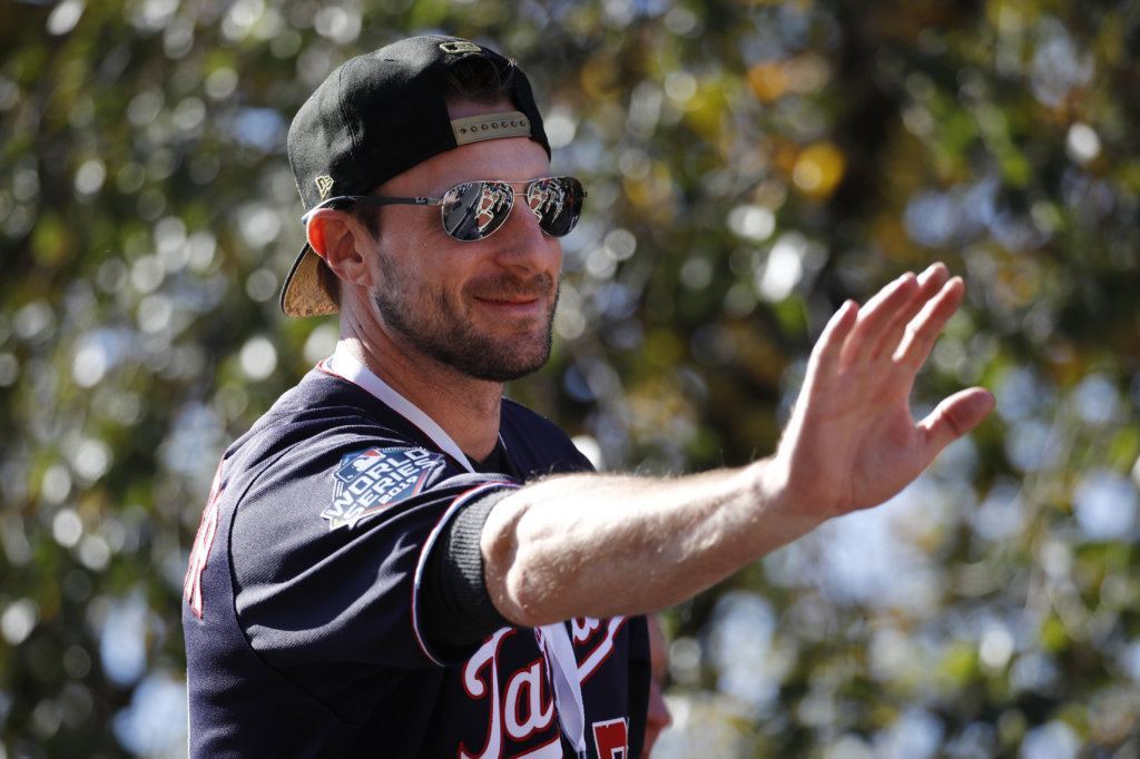 Washington Nationals starting pitcher Max Scherzer waves to fans before a parade to celebrate the team's World Series baseball championship over the Houston Astros, Saturday, Nov. 2, 2019, in Washington. (AP Photo/Patrick Semansky)