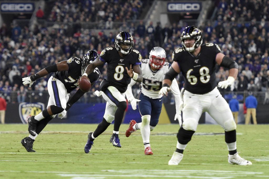 Baltimore Ravens quarterback Lamar Jackson (8) scrambles against the New England Patriots during the second half of an NFL football game, Sunday, Nov. 3, 2019, in Baltimore.