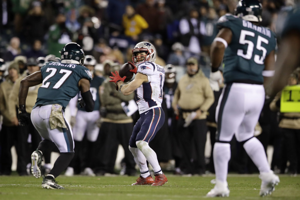 New England Patriots' Julian Edelman (11) throws a touchdown pass during the second half of an NFL football game against the Philadelphia Eagles, Sunday, Nov. 17, 2019, in Philadelphia.