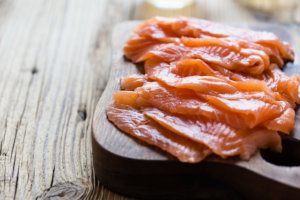 Homemade smoked salmon on wooden board