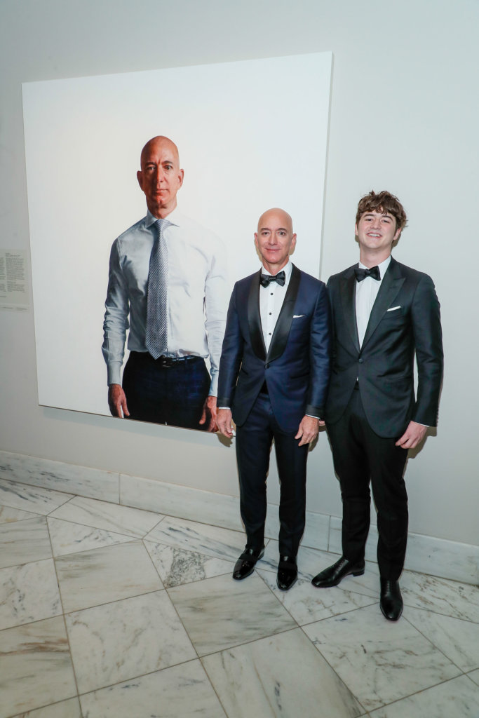 Jeff Bezos and his son, Preston, pose in front of his portrait at the gallery gala.