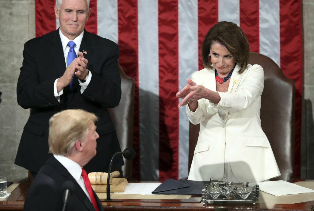 President Donald Trump turns to House Speaker Nancy Pelosi of Calif., as he delivers his State of the Union address to a joint session of Congress on Capitol Hill in Washington, as Vice President Mike Pence watches, on Feb. 5, 2019.