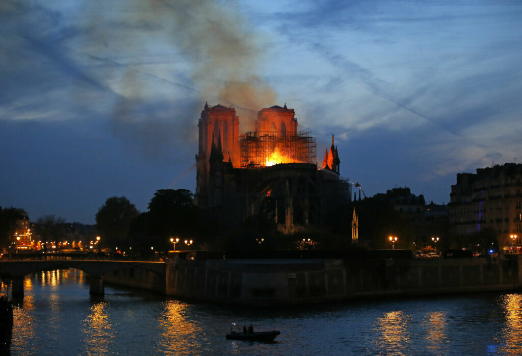 Flames and smoke rise from Notre Dame cathedral in Paris as firefighters tackle the blaze on April 15, 2019.