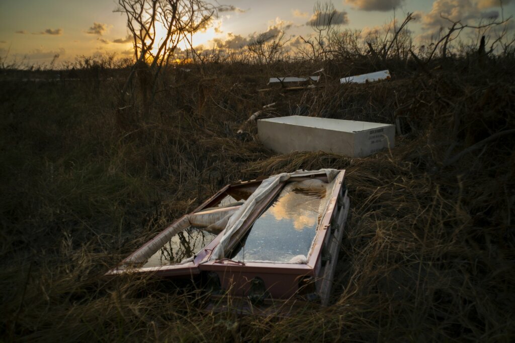 A shattered and water-filled coffin lies exposed to the elements in the aftermath of Hurricane Dorian, at the cemetery in Mclean's Town, Grand Bahama, Bahamas, on Sept. 11, 2019.