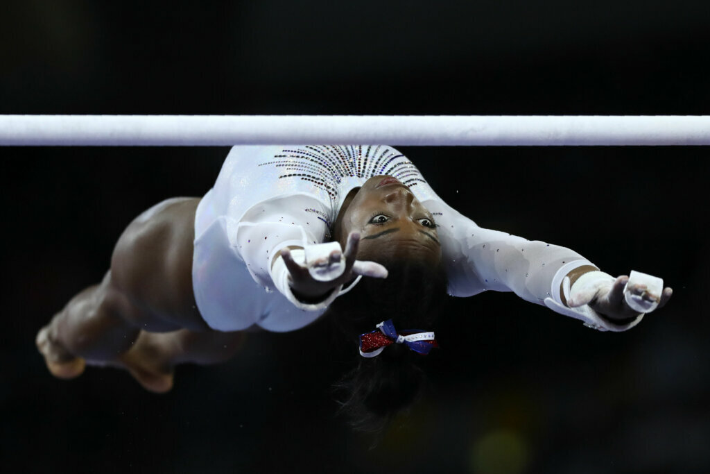 Simone Biles of the United States performs on the uneven bars during a warmup for the women's all-around final at the Gymnastics World Championships in Stuttgart, Germany, on Oct. 10, 2019.