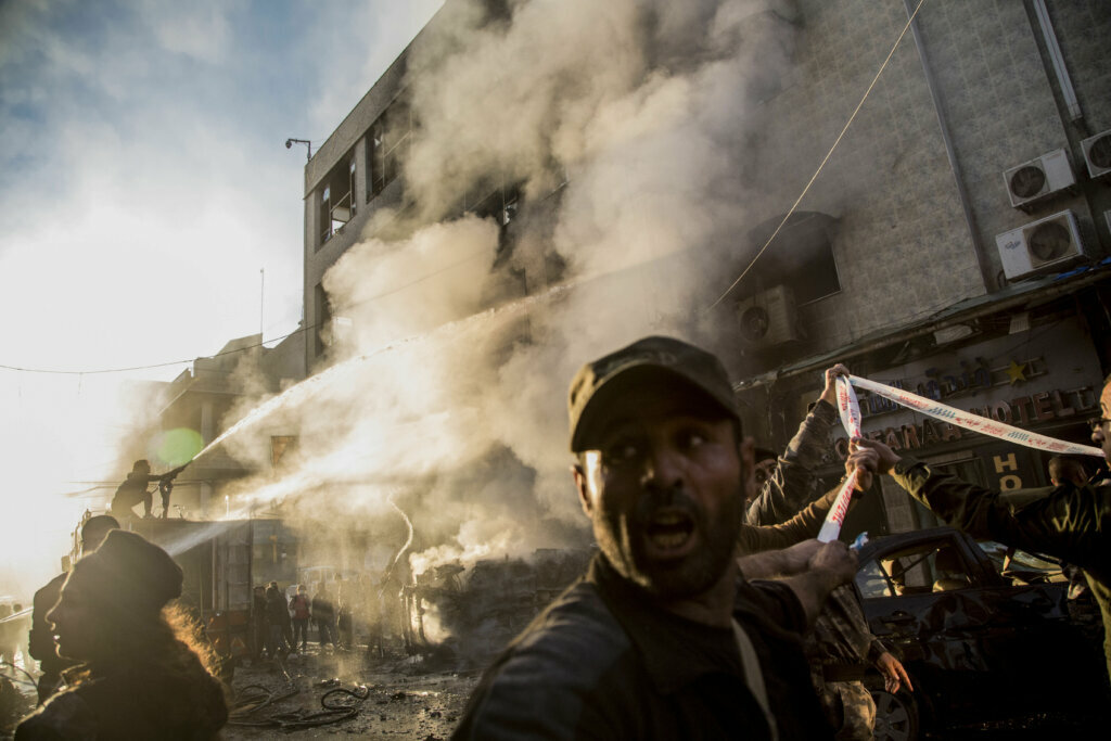 Firemen spray water after a car bomb exploded in the city of Qamishli, northern Syria, on Nov. 11, 2019.