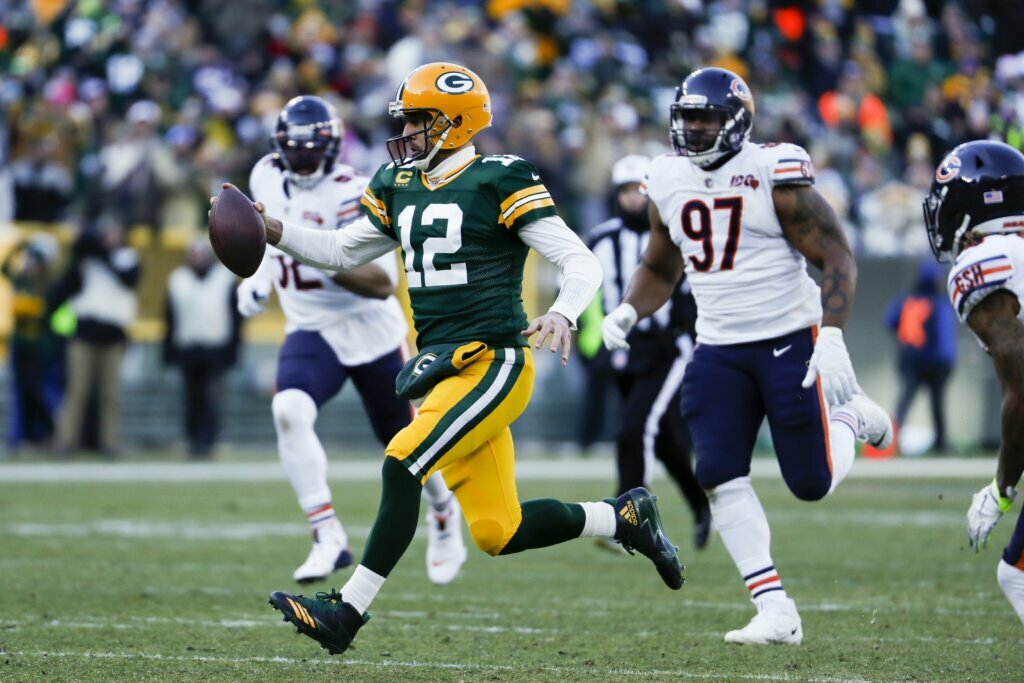 Green Bay Packers' Aaron Rodgers runs for a first down during the second half of an NFL football game against the Chicago Bears Sunday, Dec. 15, 2019, in Green Bay, Wis.