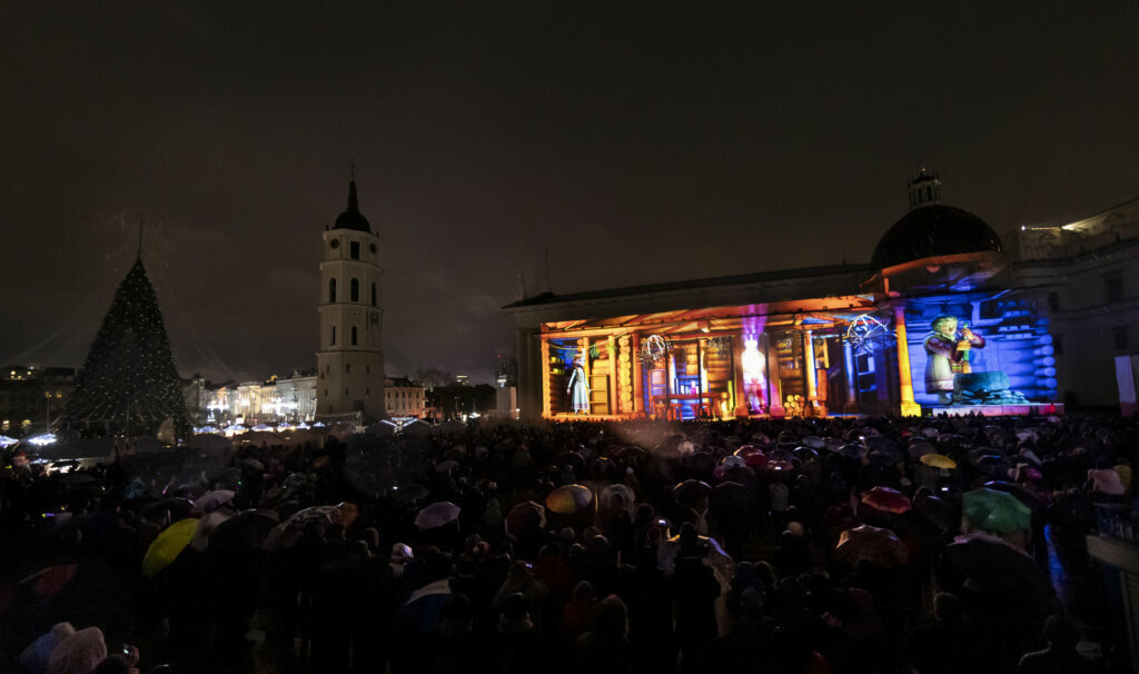 A large crowd watch a light show projected onto the Cathedral-Basilica during the Christmas celebration at Cathedral square in Vilnius, Lithuania, Wednesday, Dec. 25, 2019. Over 80 percent of Lithuanians are Christians who celebrate the festival of Christmas on Dec. 25.