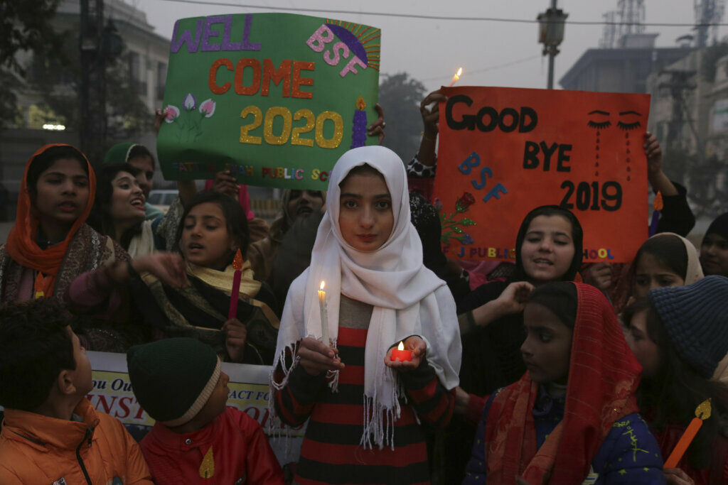 Pakistani children hold a candlelight vigil to pay tribute to victims of terrorism in 2019, at rally in Lahore, Pakistan, Tuesday, Dec. 31, 2019.
