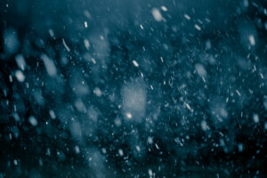 Snowfall against black background.