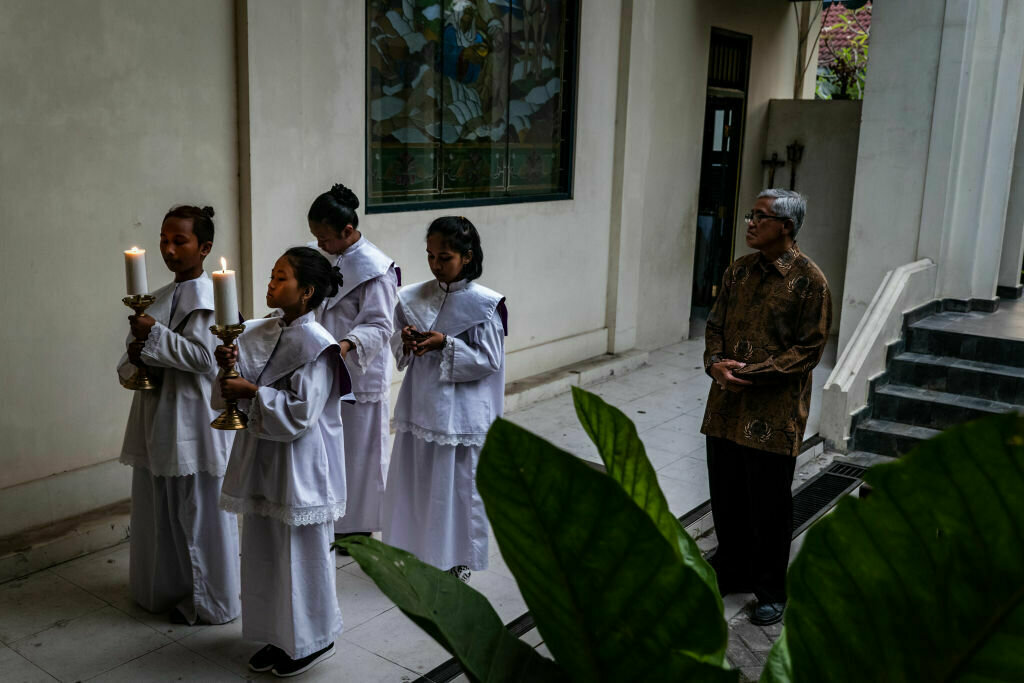 Indonesian Christian girls hold candles during Christmas Eve mass at Ganjuran Catholic church on Dec. 24, 2019 in Yogyakarta, Indonesia.