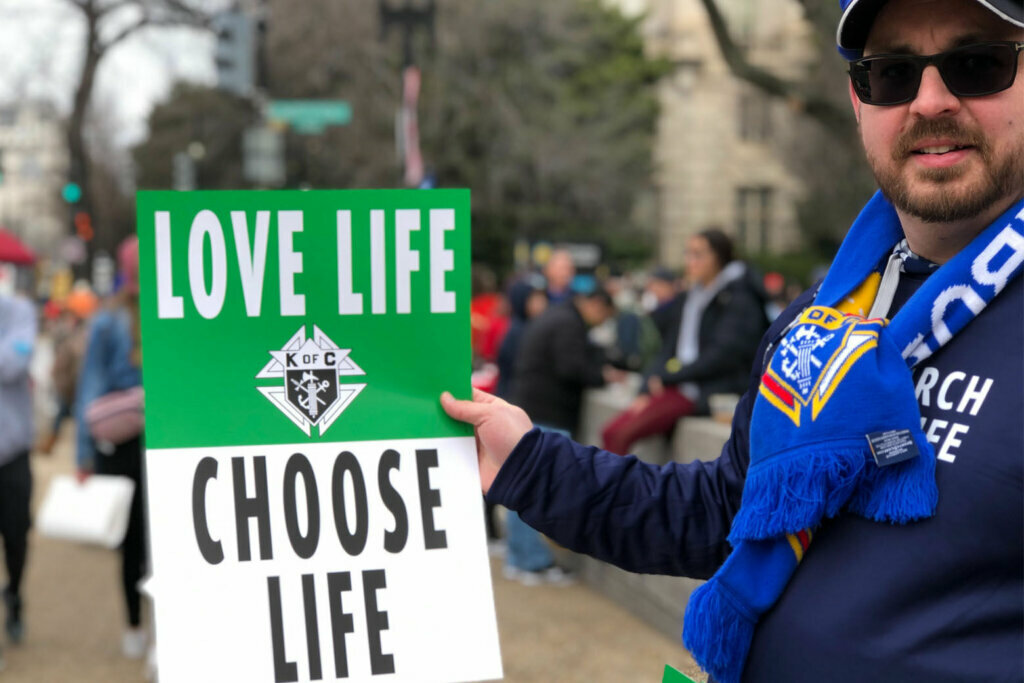 A rallygoer at the 47th annual March for Life holds a sign.