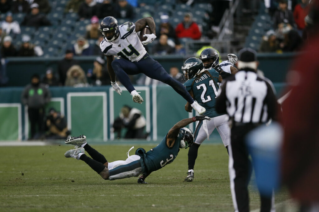 Seattle Seahawks' DK Metcalf (14) leaps over Philadelphia Eagles' Jalen Mills (31) during the second half of an NFL football game, Sunday, Nov. 24, 2019, in Philadelphia.