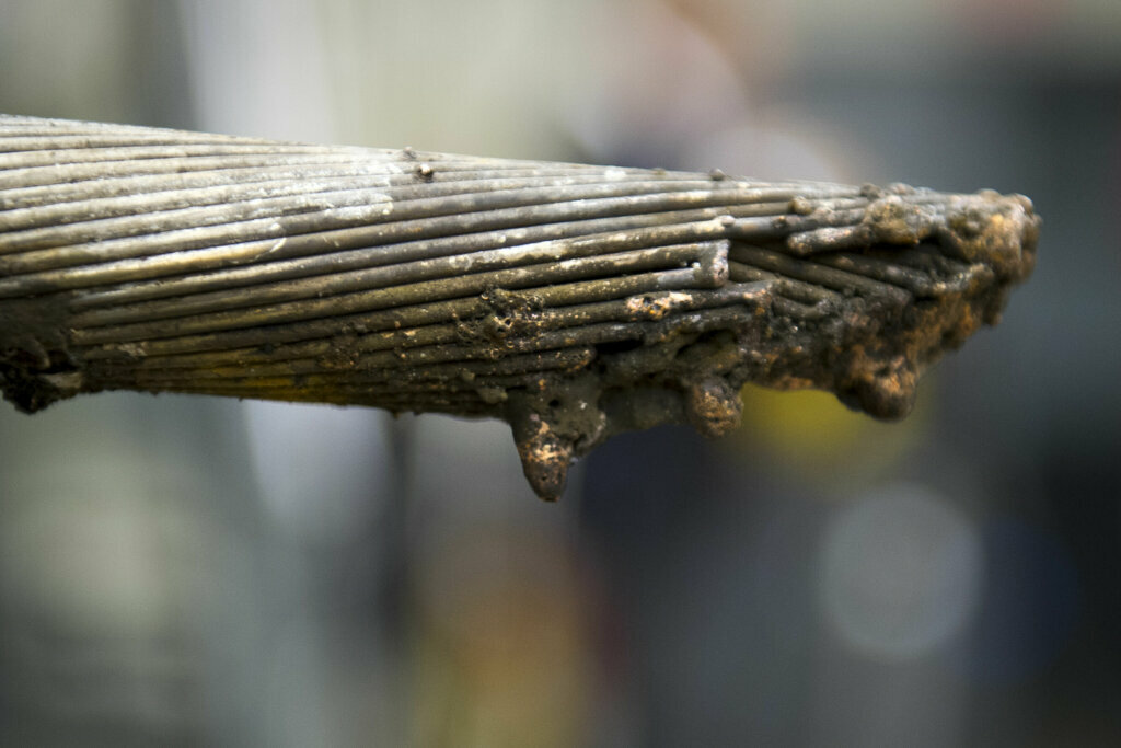 A burnt traction power cable which was melted in half is displayed in the Materials Laboratory at the National Transportation Safety Board in Washington, Thursday, Feb. 12, 2015, from the tunnel where the Jan. 12 electrical arcing and smoke event occurred in the Washington Metro subway where a woman died.