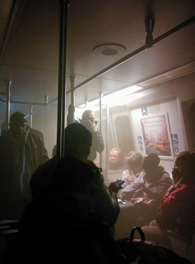 Smoke fills a Washington Metro system subway car near the L'Enfant Plaza station in Washington, Monday, Jan. 12, 2015. The transit network in the nation's capital remained hobbled Tuesday morning after an electrical malfunction that filled the busy subway station with smoke, killing one woman and sending dozens of people to hospitals.