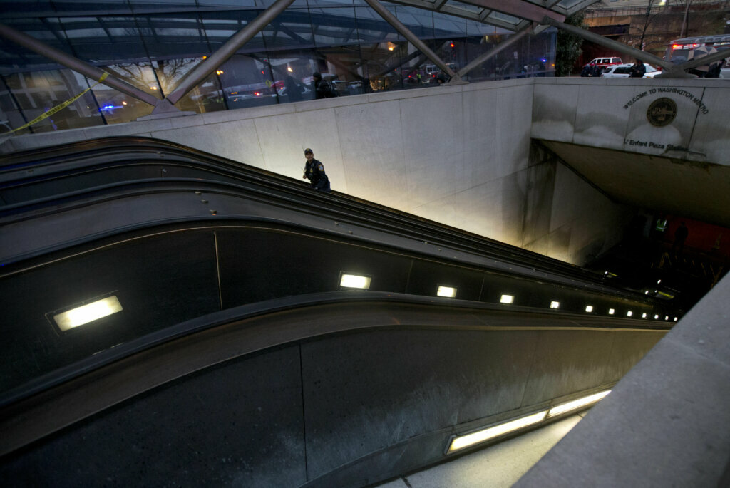A Metro Transit Police officer walks up the escalator at LEnfant Plaza Station in Washington, Monday, Jan. 12, 2015, following an evacuation. Metro officials say one of the busiest stations in downtown Washington has been evacuated because of smoke. Authorities say the source of the smoke is unknown.