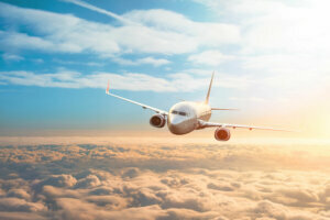 Passenger plane, business trip, travel concept. Flying evening sunset.