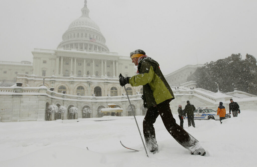 Travis Grout uses his cross-country snow skis to get around the West Front of the Capitol in Washington, Saturday, Feb. 6, 2010.