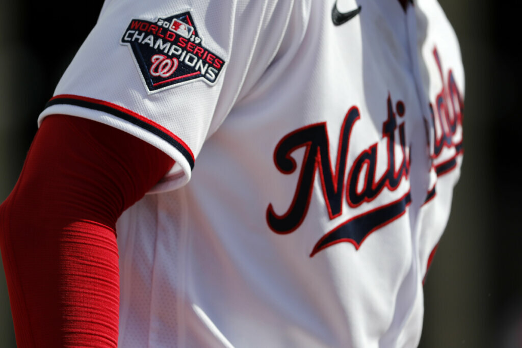 Washington Nationals pitcher Patrick Corbin wears a World Series Champions patch on his jersey while throwing a bullpen session during spring training baseball practice Monday, Feb. 17, 2020, in West Palm Beach, Fla. The Nationals defeated the Houston Astros in the World Series last season.