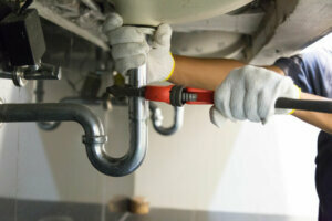 Plumber fixing pipe