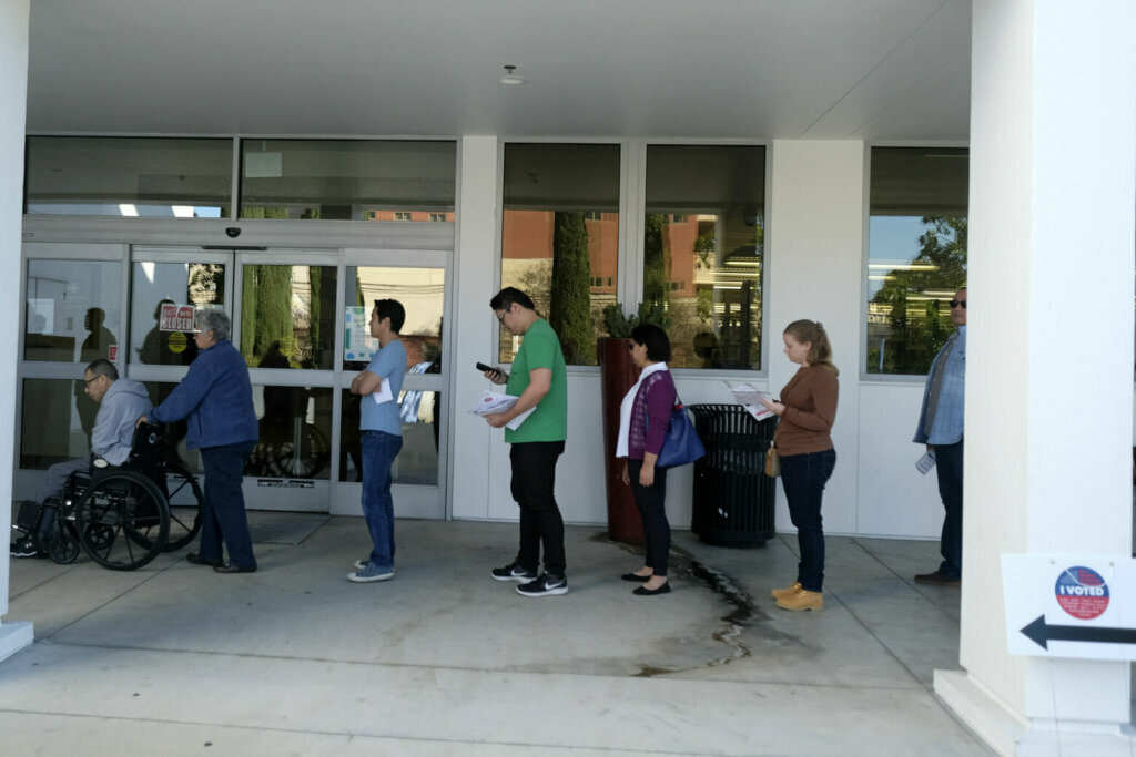 Voters wait in line to cast their ballot on the Super Tuesday, at a voting center in Alhambra, Calif., Tuesday, March 3, 2020.
