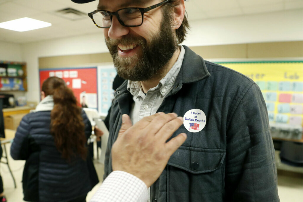 Democrat Jamie Wilson gets a sticker after voting in the Super Tuesday primary at John H. Reagan Elementary School in the Oak Cliff section of Dallas, Tuesday, March 3, 2020.