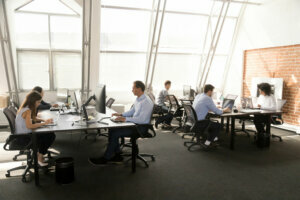 Diverse workers sitting at desk working in coworking space