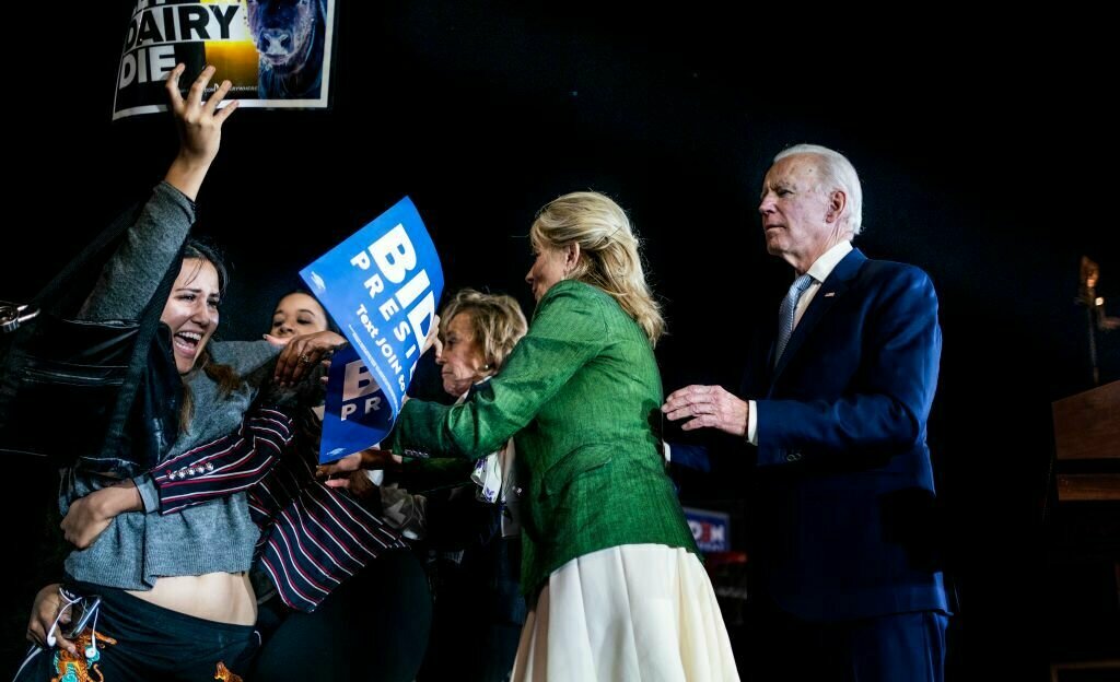 Democratic presidential candidate former Vice President Joe Biden, accompanied by his wife Dr. Jill Biden, cope with protesters that got up on the stage during a Super Tuesday election night party at Baldwin Hills Recreation Center in Los Angeles, California on Tuesday, March 3, 2020.