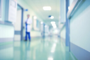 Doctor in hospital corridor, unfocused background