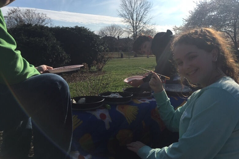 Many families are using this time to bond, like this one during a meal outside.