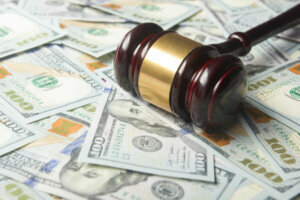 Judges Or Auctioneer Gavel On The Dollar Cash Background, Top View, Close Up. Concept For Corruption, Bankruptcy, Bail, Crime, Bribing, Fraud, Auction Bidding, Fines
