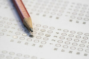 Close up red pencil on answer sheets, education concept