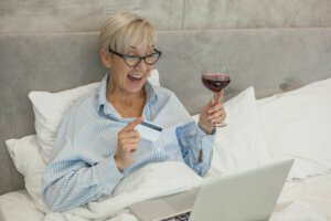 Cheerful senior woman shopping online
